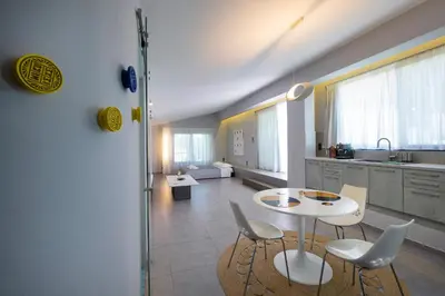 a kitchen with a table and chairs in a room at Cretan Loft in Plataniás
