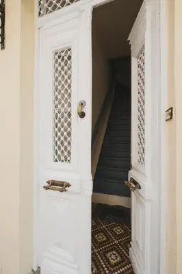 a white door in a hallway with a staircase at Home with Terrace in Heart of old Town of Chania in Chania Town