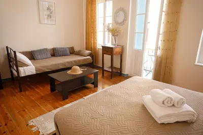 a living room with two beds and a couch at Home with Terrace in Heart of old Town of Chania in Chania Town