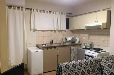 a small kitchen with a sink and a stove at Amelie Qute Apartment in Chania Town
