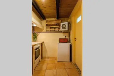 a small kitchen with a refrigerator and a stove at History and Charm in Chania Town
