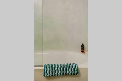 a white bath tub with a blue and white rug at History and Charm in Chania Town