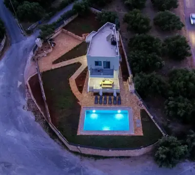 an aerial view of a house and a swimming pool at Horizon Villa Almyrida in Almirida
