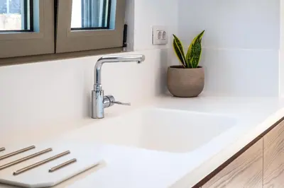 a kitchen sink with a plant on the counter at Horizon Villa Almyrida in Almirida