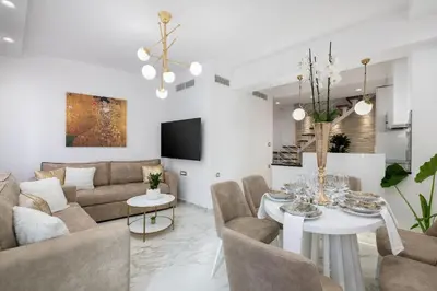 a living room with a couch and a table at Castello Luxury Residence with Private Jacuzzi in Chania Town