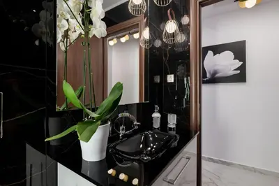 a bathroom with a black sink and a mirror at Castello Luxury Residence with Private Jacuzzi in Chania Town