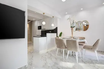 a white dining room with a table and chairs at Castello Luxury Residence with Private Jacuzzi in Chania Town