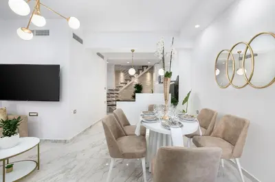 a white dining room with a white table and chairs at Castello Luxury Residence with Private Jacuzzi in Chania Town
