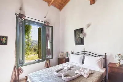 a bedroom with a bed with a window at Authentic Cottage in a heaven of natural Beauty in Chania Town