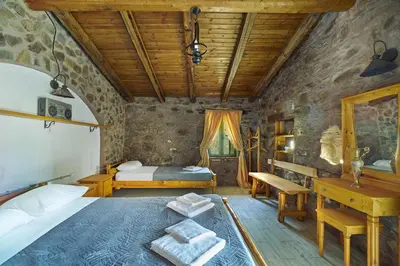 a bedroom with a bed and a desk in a room at Authentic Cottage in a heaven of natural Beauty in Chania Town