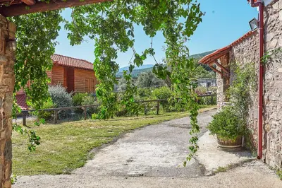 a garden with a stone wall and a pathway at Authentic Cottage in a heaven of natural Beauty in Chania Town
