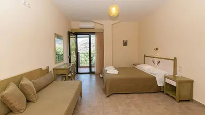 a living room with a bed and a couch at Anopoli Rooms in Anopoli Sfakion