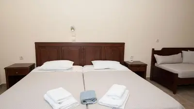 a bedroom with two beds with towels on them at Anopoli Rooms in Anopoli Sfakion
