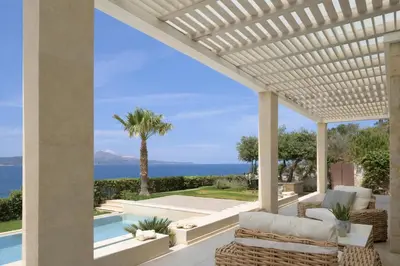 an outdoor patio with a view of the ocean at Miraida Exclusive Residence in Almirida