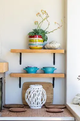 a shelf with bowls and a vase on it at Miraida Exclusive Residence in Almirida