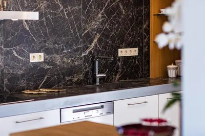 a kitchen with a marble counter top and a sink at Miraida Exclusive Residence in Almirida