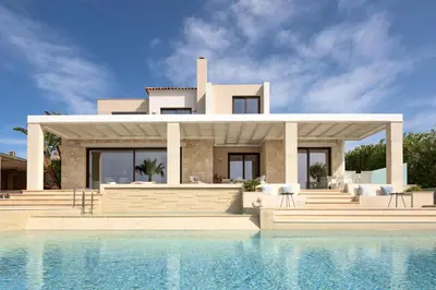 a villa with a swimming pool in front of a house at Miraida Exclusive Residence in Almirida