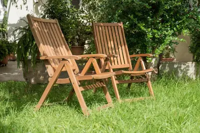 two wooden chairs sitting next to each other in the grass at Peraspitaki in Chania Town