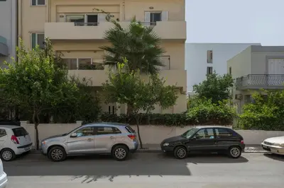 three cars parked in a parking lot in front of a building at Peraspitaki in Chania Town