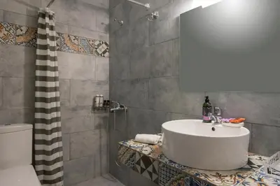 a bathroom with a sink and a shower at Peraspitaki in Chania Town