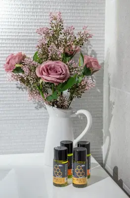 a white vase with a bouquet of flowers in it at Villa Antoni in Galatás