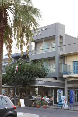 a building with people sitting outside of it at Oneiro Suites in Souda
