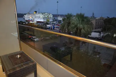 a balcony with a view of a cruise ship at Oneiro Suites in Souda