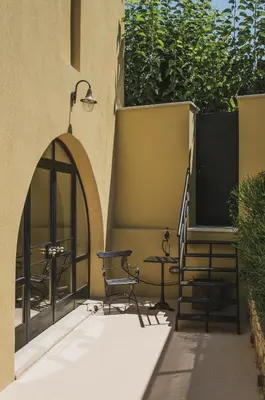 a patio with a table and a table and chairs at Casa Olea - A Venetian era Home with Courtyard in Kondomari