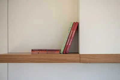 a stack of books sitting on top of a shelf at Seametry Luxury Living Penthouse in Souda