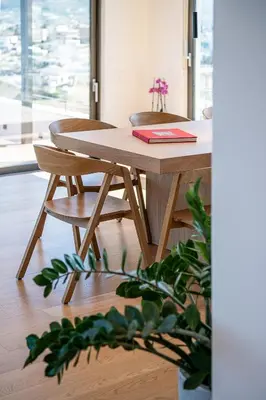 a wooden table and chair in a room at Seametry Luxury Living Penthouse in Souda