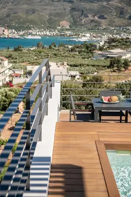 a balcony with a table and a view of a city at Seametry Luxury Living Penthouse in Souda