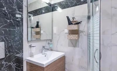 a white bathroom with a sink and a shower at Apolafsi Apartments 2 New with kitchen in Chania Town