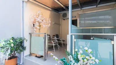a room with plants and a table in a building at Apolafsi Apartments 2 New with kitchen in Chania Town