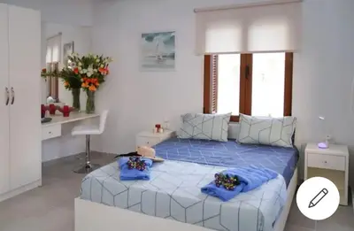 a bedroom with a blue bed with blue pillows at Apolafsi Apartments 1New with kitchen in Chania Town