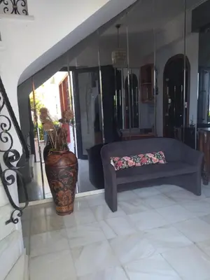 a living room with a couch and a vase at Ostria Apartments Kalives in Kalyves