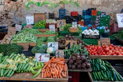 a vegetable stand with vegetables on display at a market at Sea & Town Getaway in Chania Town