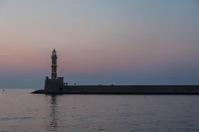 a lighthouse in the middle of a body of water at Sea & Town Getaway in Chania Town