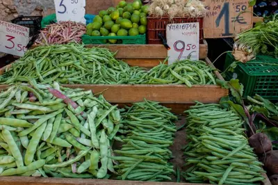 a display of green beans and other vegetables at a market at Sea & Town Getaway in Chania Town