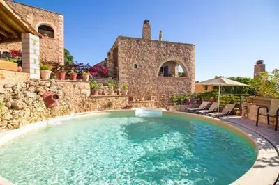 a large swimming pool in front of a house at Traditional Crete Villa Villa Green Faskomilia Stunning Views 1 Bedroom in Khiliomoudhoú