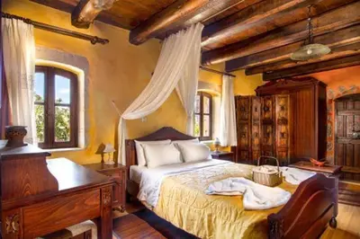 a bedroom with a bed and a desk and a piano at Traditional Crete Villa Villa Orange Diktamos Stunning Views 1 Bedroom in Khiliomoudhoú