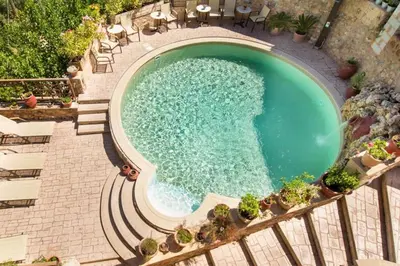 an overhead view of a swimming pool with chairs at Traditional Crete Villa Villa Orange Diktamos Stunning Views 1 Bedroom in Khiliomoudhoú
