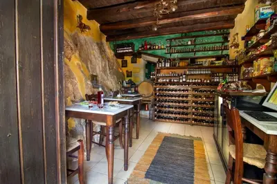 a wine tasting room with tables and racks of wine bottles at Traditional Crete Villa Villa Orange Diktamos Stunning Views 1 Bedroom in Khiliomoudhoú