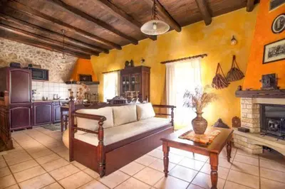 a living room with a couch and a fireplace at Traditional Crete Villa Villa Orange Diktamos Stunning Views 1 Bedroom in Khiliomoudhoú