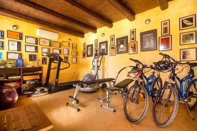 two bikes parked in a room with a gym at Traditional Crete Villa Villa Blue Mantzourana Stunning Views 1 Bedroom in Khiliomoudhoú