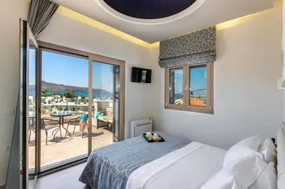 a bedroom with a bed and a balcony at Luxury Villa Crete Villa Marina Mare 3 Bedroom Private Pool in Chania Town