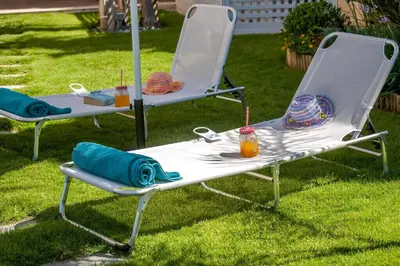 two lawn chairs sitting in the grass with drinks on them at Luxury Villa Crete Villa Marina Mare 3 Bedroom Private Pool in Chania Town