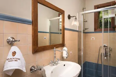 a bathroom with a sink and a mirror at Luxury Crete Villa Villa Koukounari Private Pool Beautiful Scenery in Chania Town