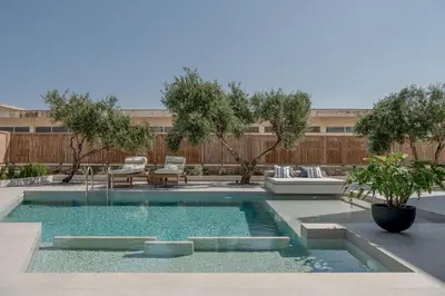 a swimming pool in a backyard with a couch and chairs at Anthos Villas - Chania in Tavronitis