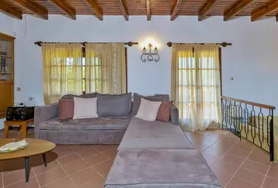 a living room with a couch and a table at Exclusive Crete Villa Villa Alexia 4 Bedrooms Large Lawned Gardens in Maleme
