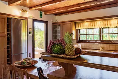 a kitchen with a table with a bowl of fruit on it at Exclusive Crete Villa Villa Alexia 4 Bedrooms Large Lawned Gardens in Maleme